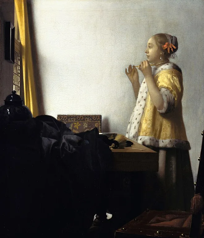 Woman with a Pearl Necklace by Johannes  Vermeer, 1663